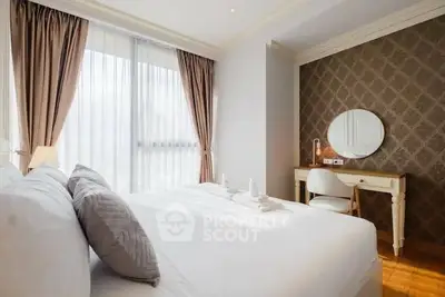 Elegant bedroom with natural light, stylish decor, and cozy ambiance for ultimate relaxation.