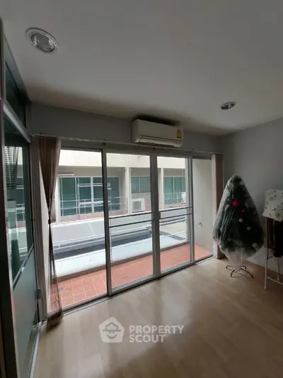 Spacious room with large windows and air conditioning, ideal for modern living.