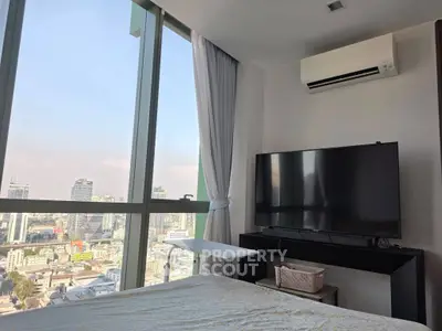 Modern bedroom with city view, large TV, and air conditioning