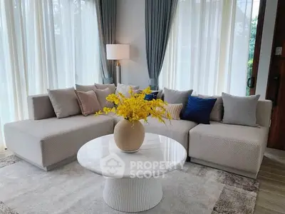 Elegant living room with modern sofa, stylish coffee table, and bright decor accents.