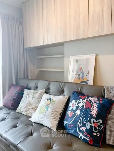 Stylish living room with modern decor and cozy cushions on a sleek sofa, perfect for relaxation.