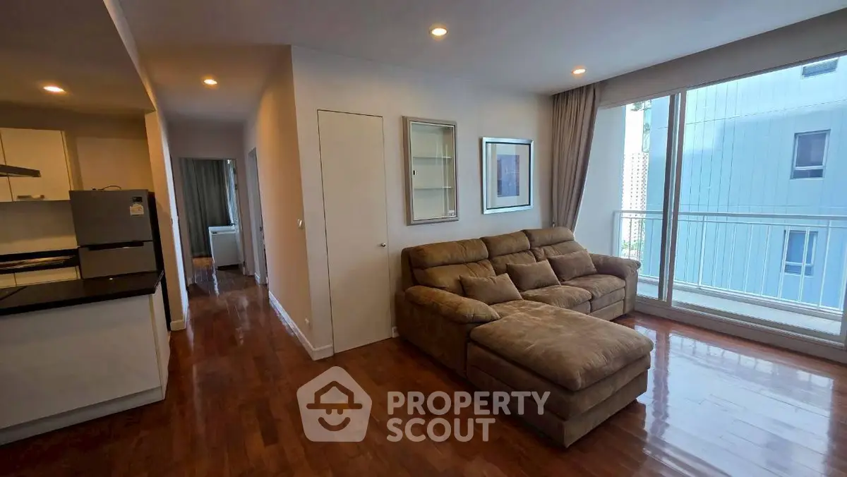 Spacious living room with modern sofa and large window for natural light.
