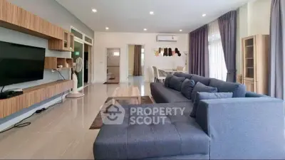 Spacious modern living room with elegant decor and ample natural light.