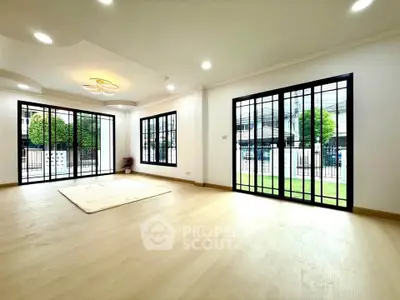 Spacious modern living room with large windows and elegant ceiling design