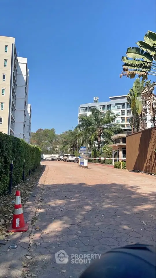Modern apartment building with lush greenery and clear blue sky