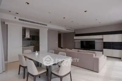 Spacious modern living room with dining area and sleek furniture in a contemporary apartment.