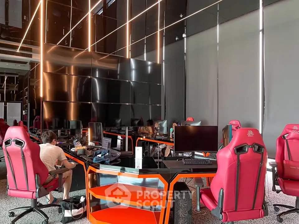 Modern co-working space with sleek design and vibrant red chairs, ideal for productivity and collaboration.