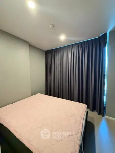 Cozy bedroom with soft lighting and elegant curtains, perfect for restful nights.