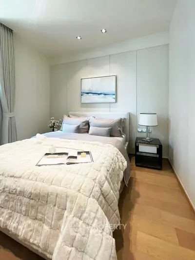 Elegant bedroom with cozy bedding and modern decor, perfect for relaxation and comfort.