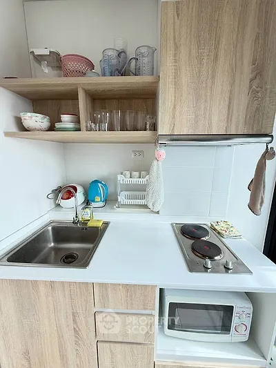 Compact modern kitchen with wooden cabinets and electric stove