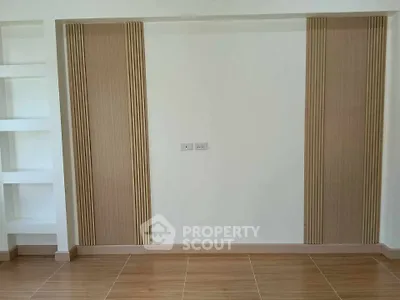 Modern minimalist interior wall with wood panel accents and built-in shelving
