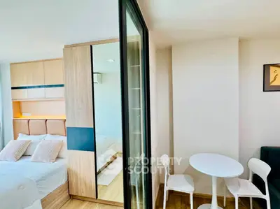 Modern bedroom with stylish decor and cozy dining area in a contemporary apartment.