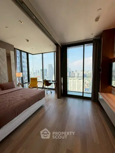 Luxurious bedroom with stunning city view and modern furnishings in high-rise apartment.