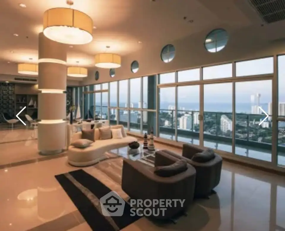 Luxurious living room with panoramic city and ocean views, modern furniture, and elegant lighting.