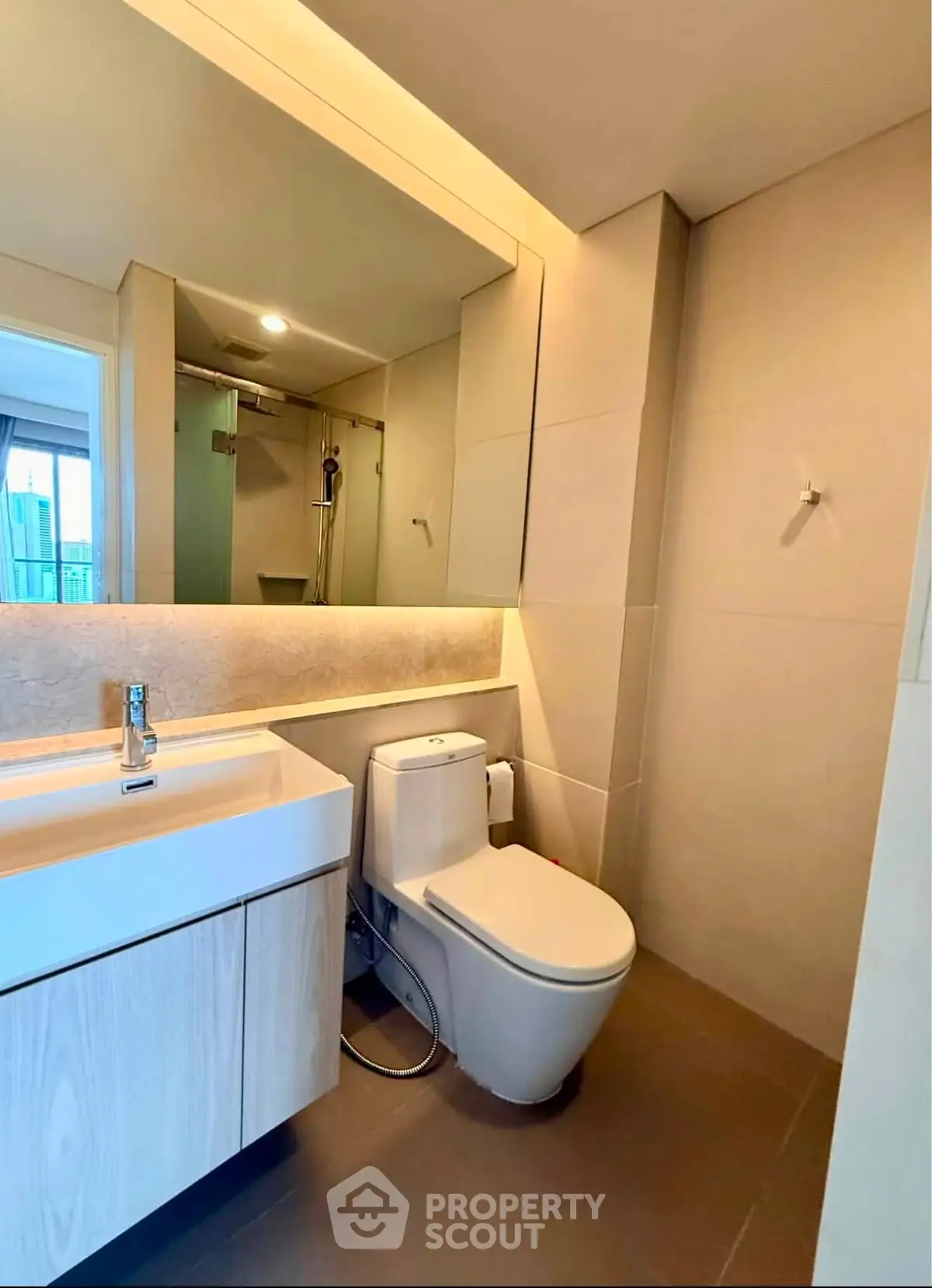 Modern bathroom with sleek fixtures and spacious shower in a contemporary apartment.