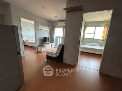 Spacious apartment interior with two bedrooms and a cozy living area, featuring modern furnishings and natural light.