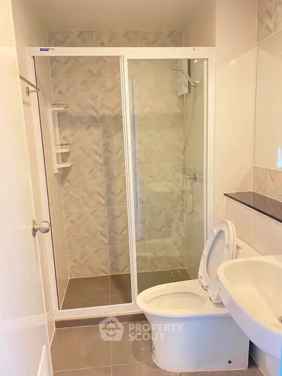 Modern bathroom with glass shower enclosure and sleek fixtures