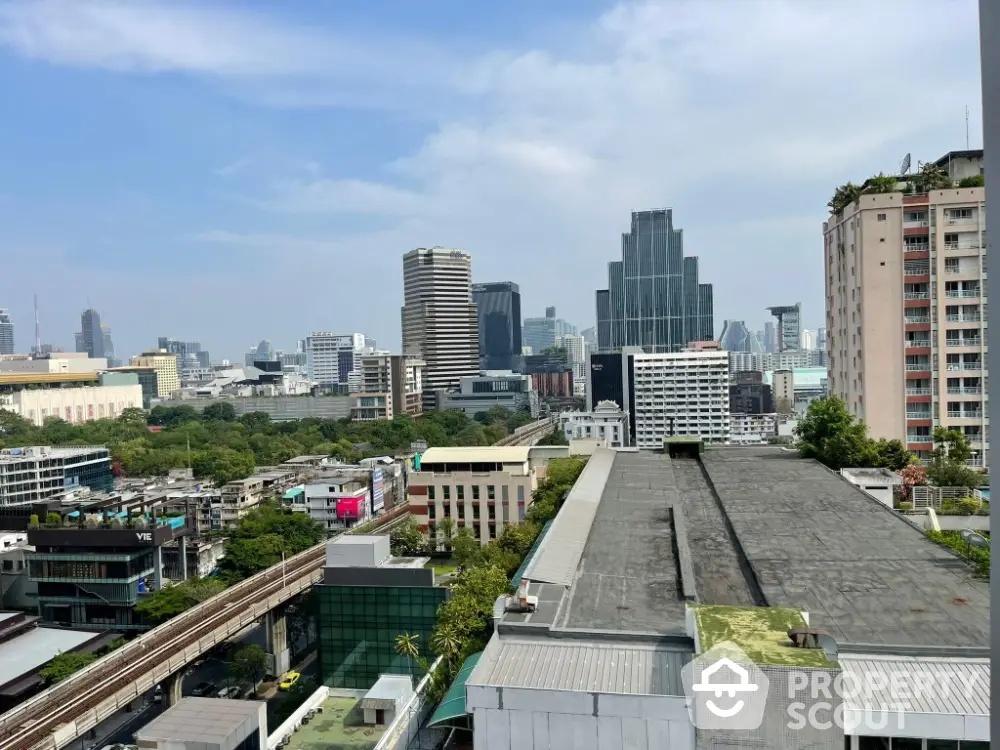 Stunning cityscape view from high-rise building showcasing urban skyline and greenery