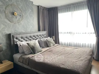 Luxurious bedroom with elegant decor and large windows for natural light.