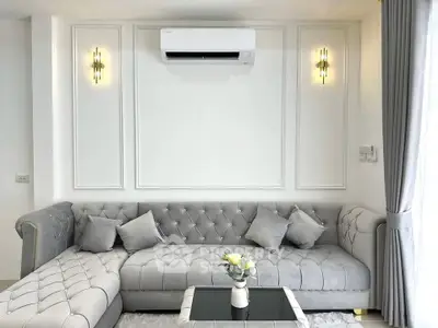 Elegant living room with plush gray sofa and modern wall sconces