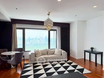 Elegant living room with city view, modern decor, and stylish chandelier.