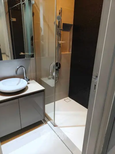 Modern bathroom with sleek shower and stylish sink vanity.