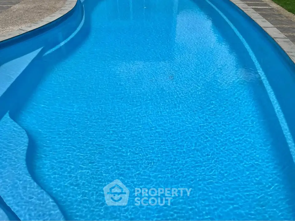 Luxurious outdoor swimming pool with crystal clear water and elegant design.