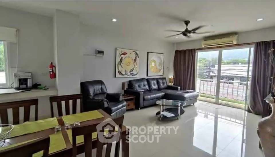 Spacious living room with modern decor and large windows offering scenic views.
