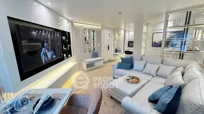 Luxurious modern living room with large sectional sofa and wall-mounted TV, perfect for entertaining.