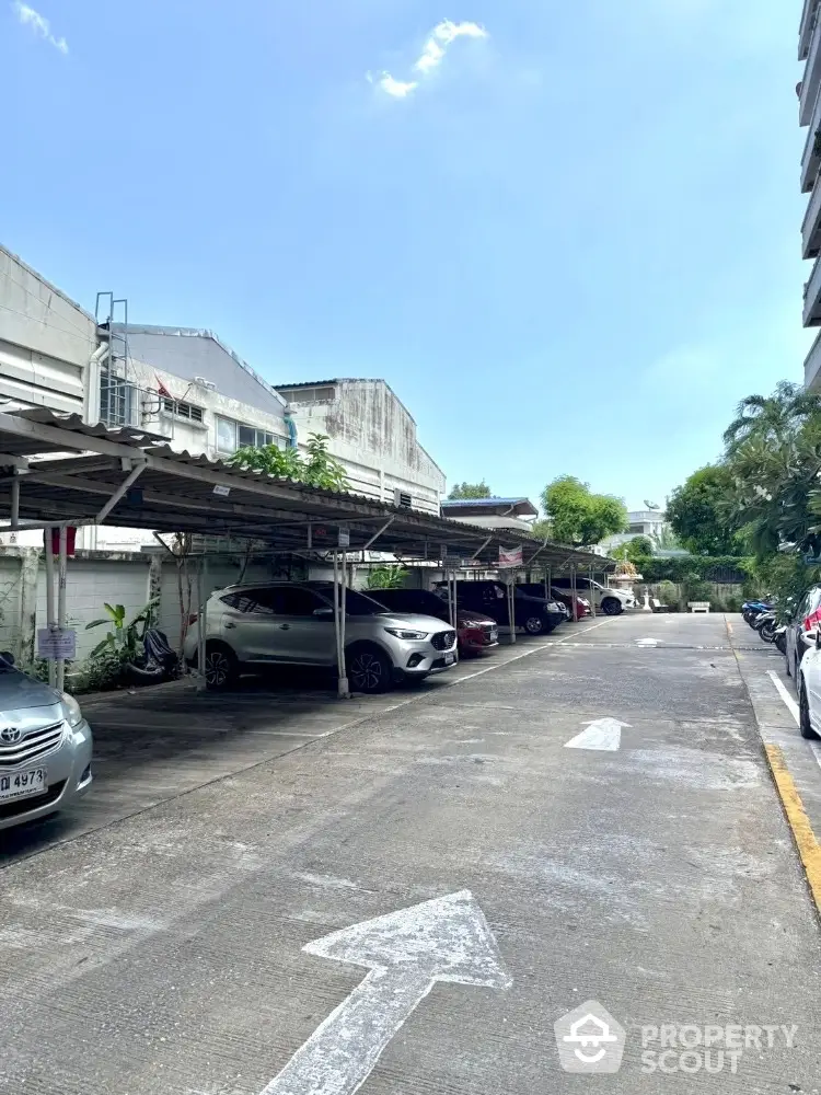 Spacious outdoor parking area with covered spaces in urban setting