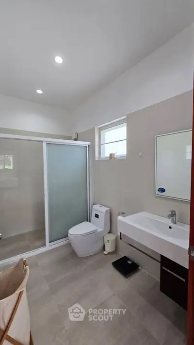 Modern bathroom with sleek fixtures and spacious shower area