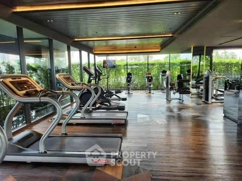 Luxurious gym with modern equipment and scenic outdoor view in upscale property.