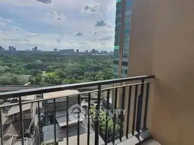 Stunning balcony view overlooking lush greenery and cityscape, perfect for relaxation and enjoying the outdoors.