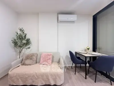 Cozy living room with modern decor and dining area in a stylish apartment.