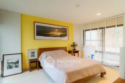 Modern bedroom with yellow accent wall and stylish decor