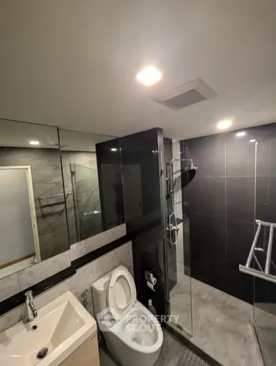 Modern bathroom with sleek design, glass shower, and contemporary fixtures.
