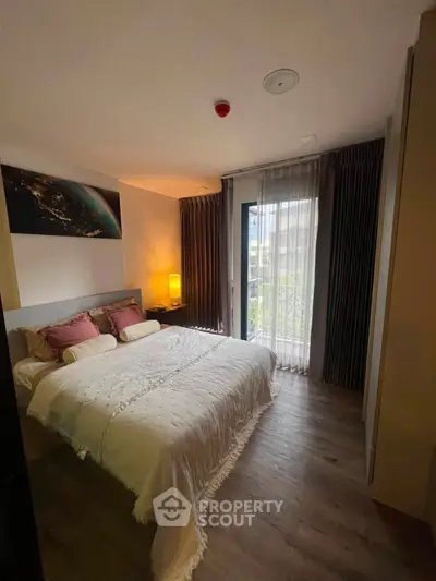 Cozy bedroom with elegant decor and natural light, featuring a comfortable bed and stylish curtains.