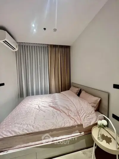 Cozy bedroom with modern decor and soft lighting, featuring a comfortable bed and stylish curtains.