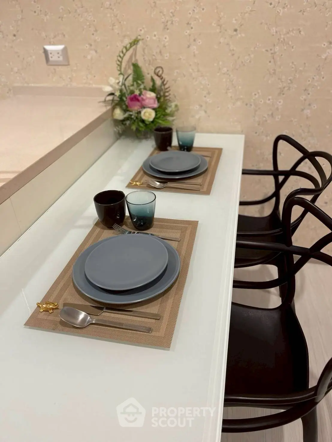 Modern dining setup with stylish chairs and elegant tableware in a cozy interior space.
