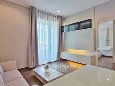 Modern living room with sleek furniture and large window for natural light