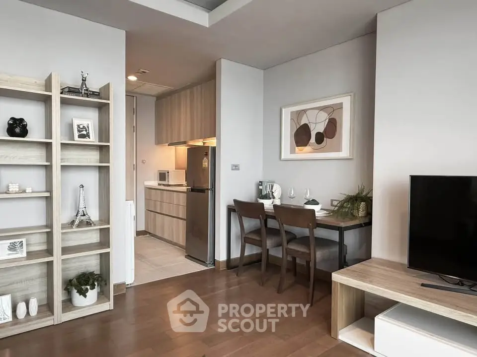 Modern living room with open kitchen and stylish decor in a cozy apartment.