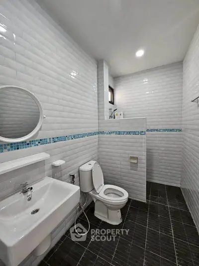 Modern bathroom with sleek white tiles and contemporary fixtures