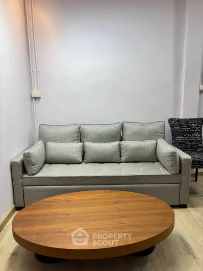 Modern living room with stylish gray sofa and wooden coffee table