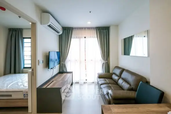 Modern living room with leather sofa and wall-mounted TV in bright apartment