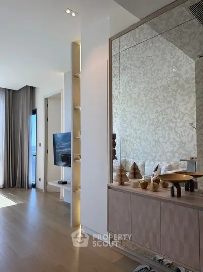 Luxurious modern living room with elegant decor and large windows offering natural light.