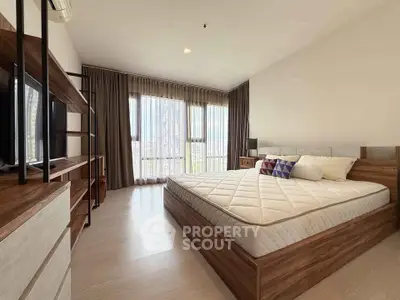 Spacious modern bedroom with large windows and stylish wooden furniture