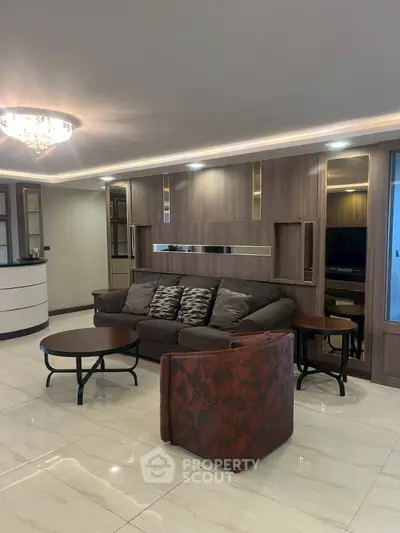 Elegant living room with modern decor and plush seating in a luxurious apartment.