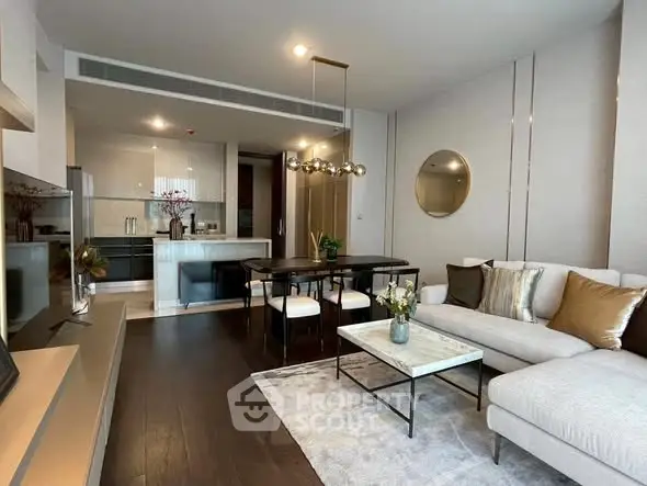 Luxurious modern living room with open kitchen, elegant decor, and stylish furniture in a high-end apartment.