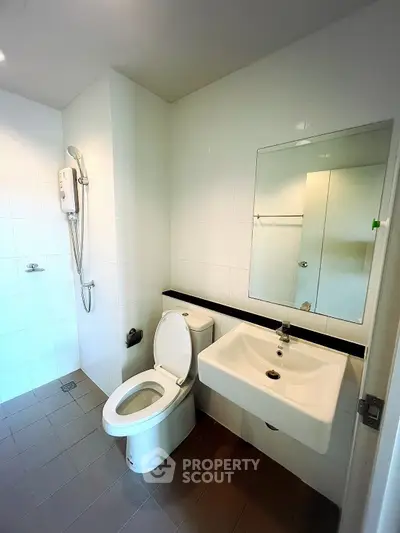 Modern bathroom with sleek fixtures and spacious shower area