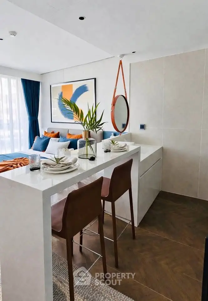 Modern living room with stylish decor and open layout, featuring a cozy seating area and elegant dining space.